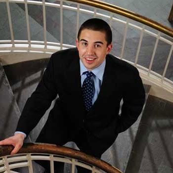Student in a suit on staircase